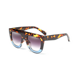 Side view of leopard and blue, flat top oversized sunglasses, with black gradient lenses.