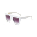 Side view of white, flat top oversized sunglasses, with black gradient lenses.