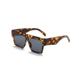 Side view of leopard print, square sunglasses, with dark lenses.