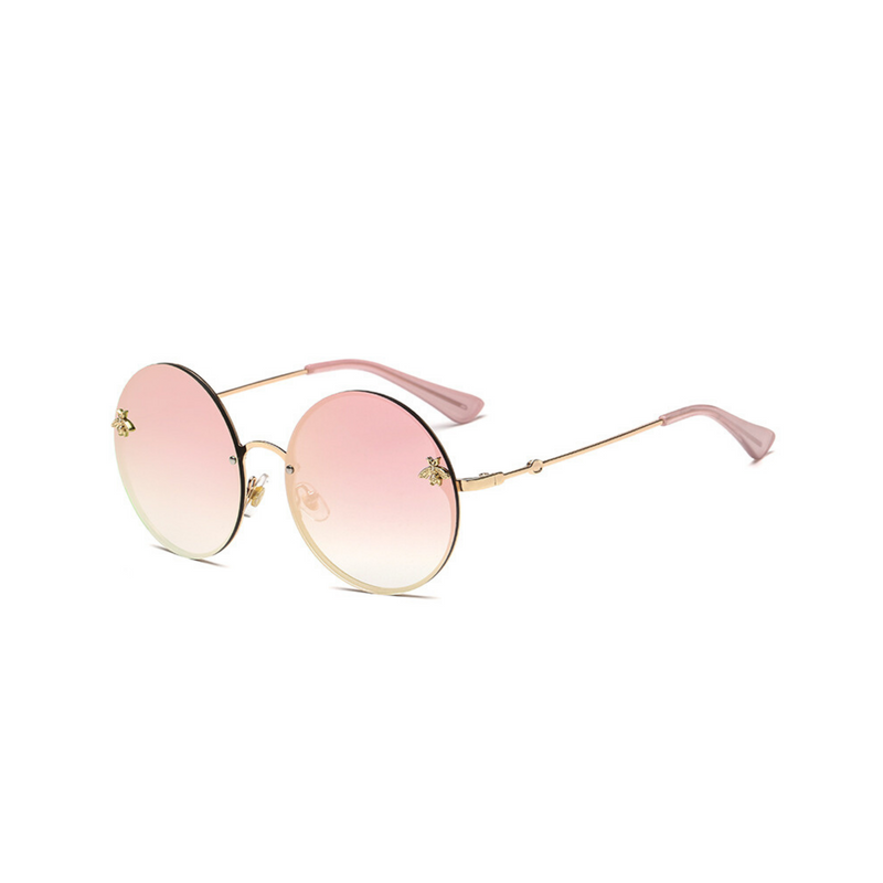 Side view of pink, large circle sunglasses, with mirror lenses and bee detail on the lenses.
