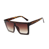 Side view of leopard, square block sunglasses, with brown gradient lenses.