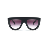 Side view of black, flat top oversized sunglasses, with black gradient lenses.