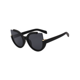 Side view of black, large cat eye sunglasses, with dark lenses.